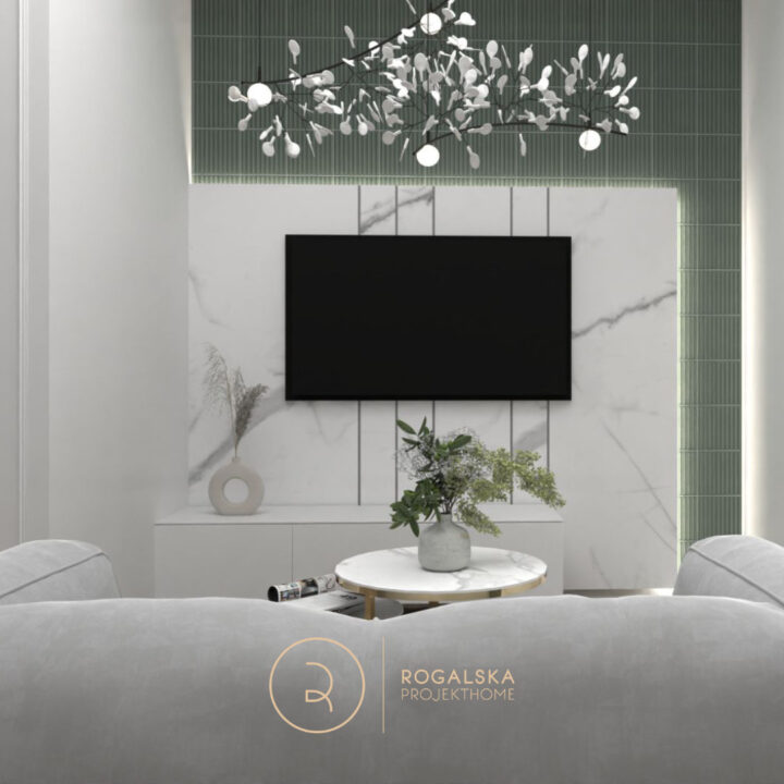 Ściana telewizyjna w Apartamencie na wynajem wykonana z kafelków Neve Creative od Ceramika Paradyż oraz z płyty imitującej marmur. Uzupełnieniem salonu jest szara welurowa sofa.