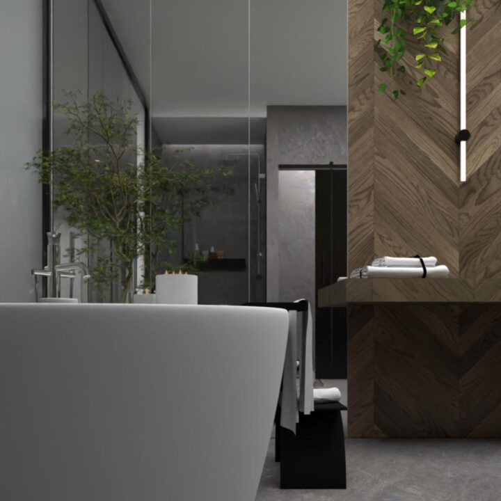 Pokój kąpielowy z wanną wolnostojącą w kolorze białym. Ściana wykończona lustrami, w których można się widzieć podczas kąpieli. Oprócz kamienia na ścianie, który nadaje surowości znalazło się również miejsce na elementy wykonane z drewna.